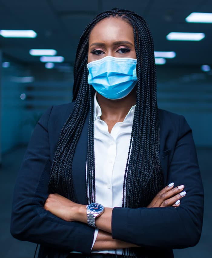 Woman in a blue suit wearing a nose mask